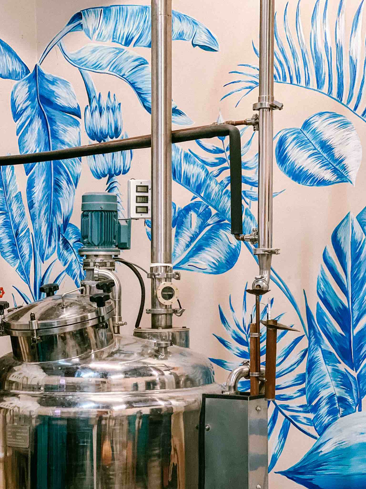 blue light Caribbean Gin still with background tropical mural